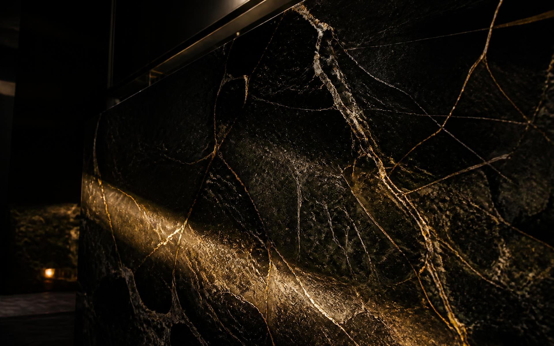 Polished black marble slab with golden veining
